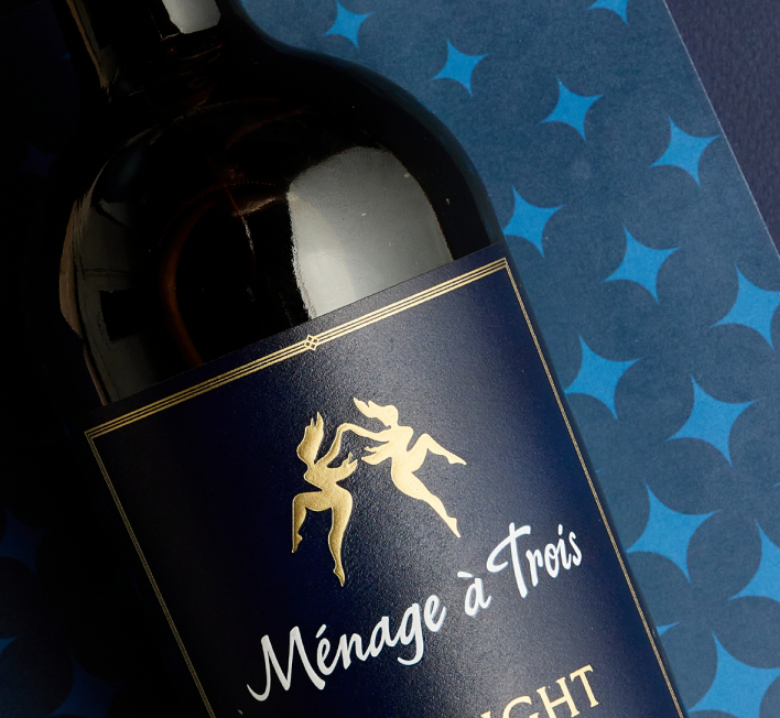 Bottle of Ménage à Trois Midnight with gold dancer figures on a dark blue label
