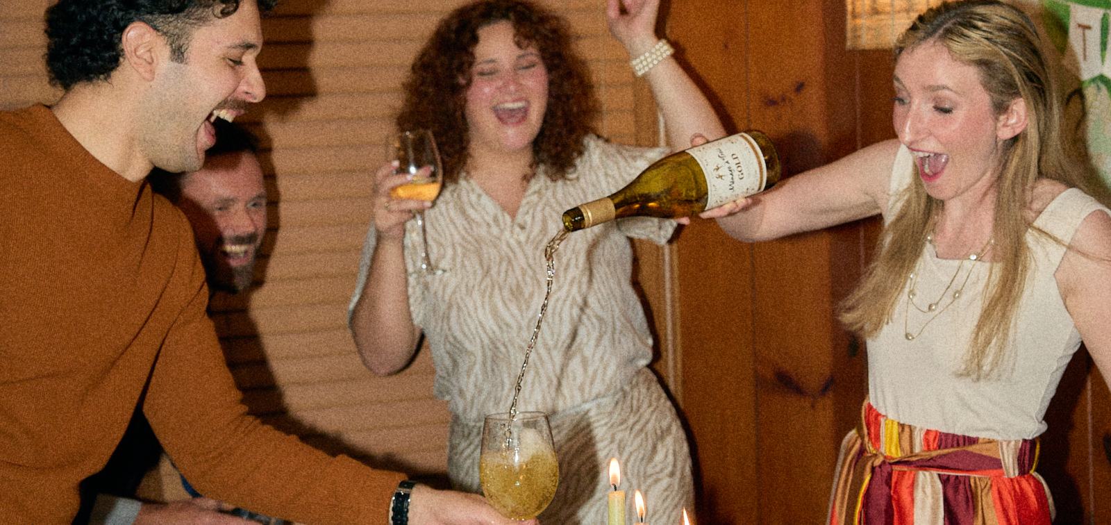 Friends celebrating with Ménage à Trois wine